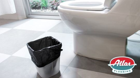 wastebasket in bathroom next to toilet