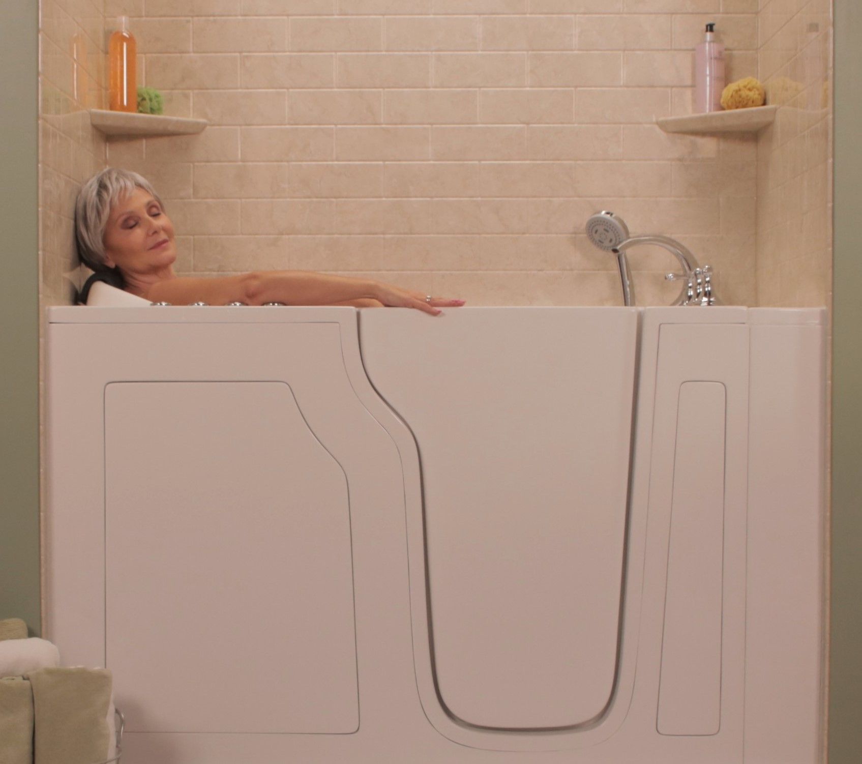 Elderly person sitting in bathtub